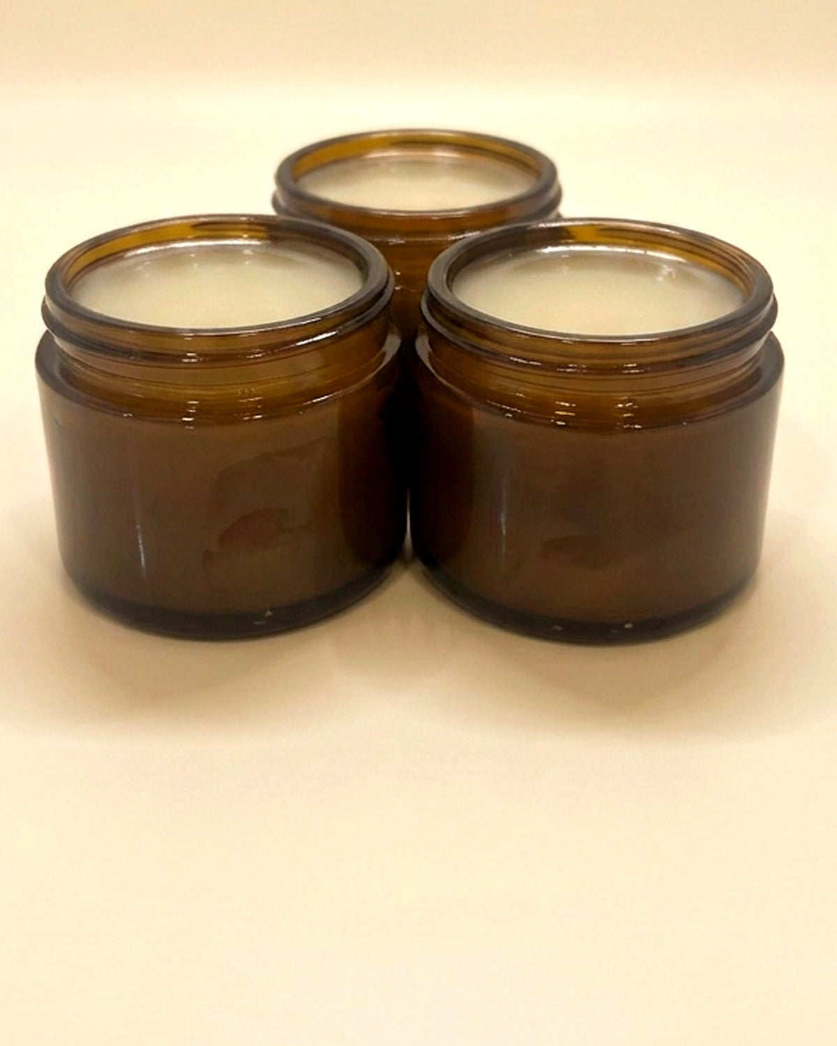 Bee & Bovine poured tallow balm in three amber glass jars