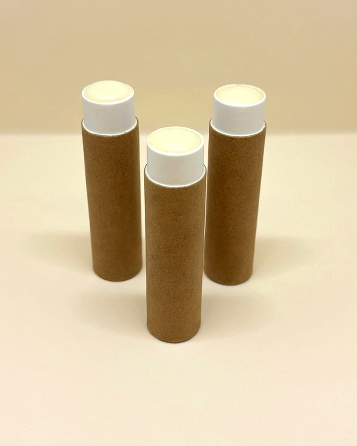 Bee & Bovine tallow lip balm in three kraft paper tubes